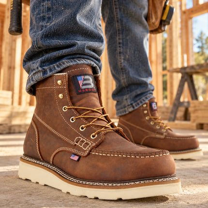 Worker wearing brown US Boot Bravo moc-toe boots with cream wedge soles inside a timber-framed construction site.