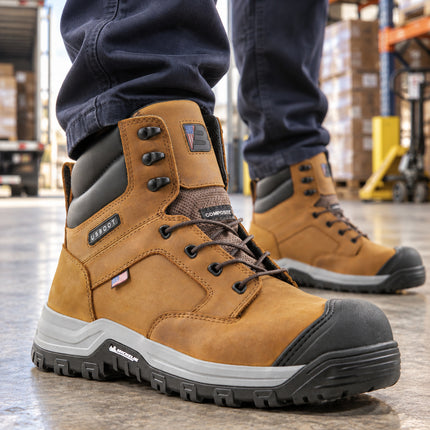 Worker wearing tan US Boot Echo boots with black toe guards and Michelin soles in a warehouse loading area.