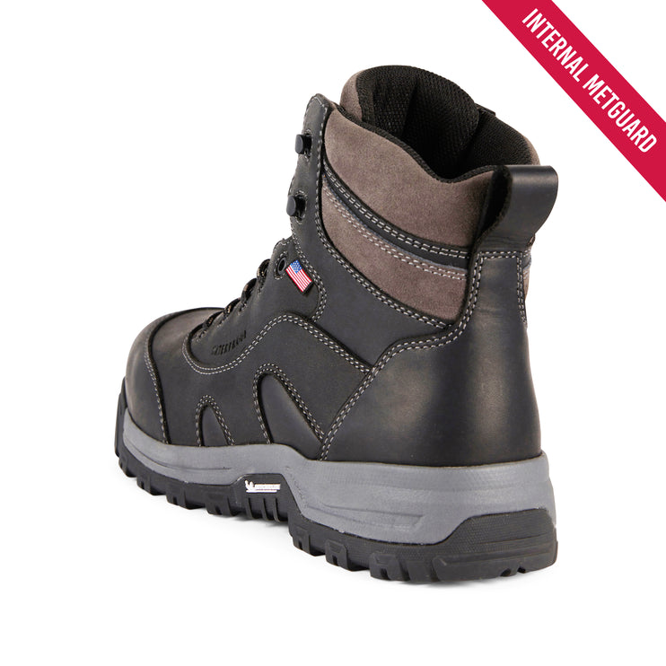A dark gray and brown work boot with a gray midsole, shown from a three-quarters angle on a white background. A red diagonal banner in the top right corner reads 'INTERNAL METGUARD'.