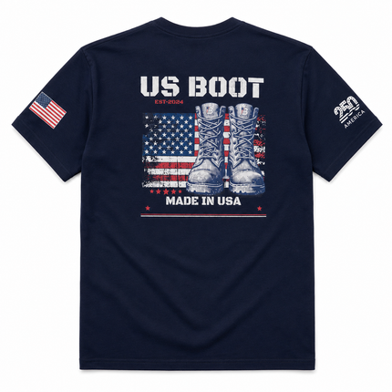 A navy blue short-sleeve t-shirt shown from the back, featuring a graphic print of combat boots over an American flag with the text 'US BOOT' and 'MADE IN USA'. The left sleeve has an American flag print, and the right sleeve features a white '250 AMERICA' logo.