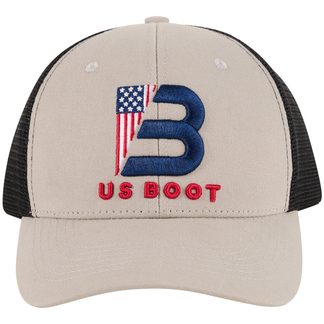 A gray trucker-style baseball cap with black mesh back panels. The front features a large embroidered blue letter 'B' filled with an American flag design, and the words 'US BOOT' embroidered in red below it.