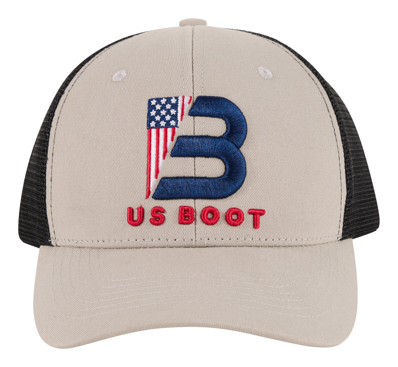 A gray trucker-style baseball cap with black mesh back panels. The front features a large embroidered blue letter 'B' filled with an American flag design, and the words 'US BOOT' embroidered in red below it.