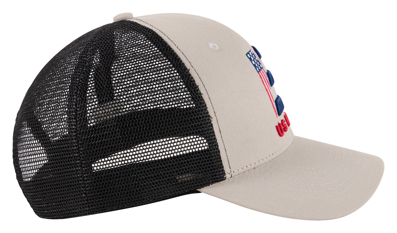 A gray and black trucker hat with a black mesh back and a beige front panel, featuring a small embroidered American flag and red text on the side.